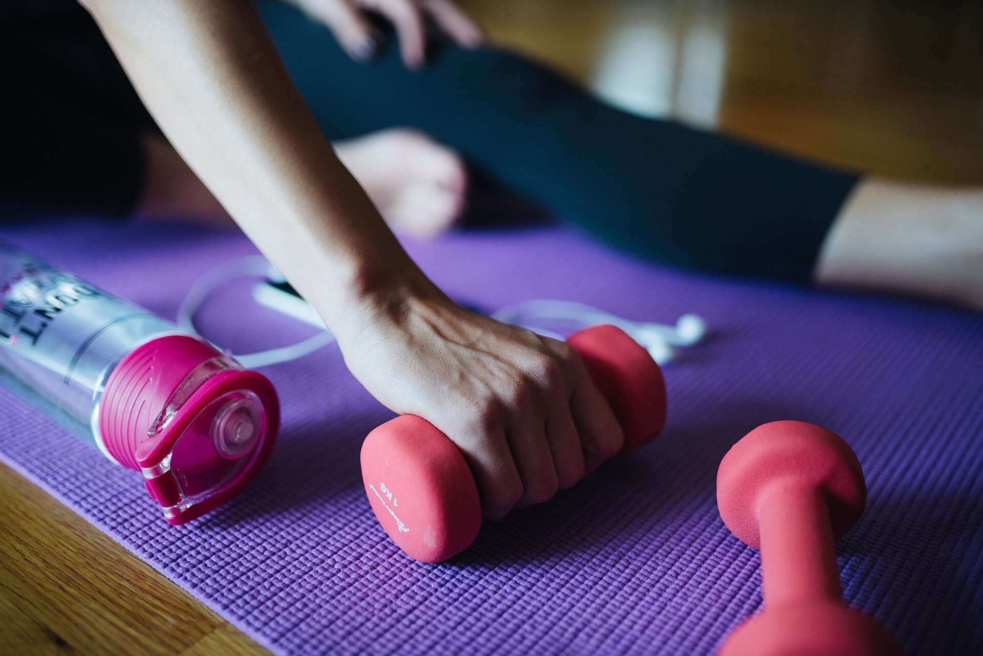 Woman exercising at home with dumbbells